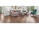 Bright living room features hardwood floors, modern decor, and comfortable seating at 2480 Roxburgh Dr, Roswell, GA 30076