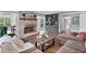 Open living room boasts hardwood floors and a brick fireplace, creating a cozy and inviting atmosphere at 2480 Roxburgh Dr, Roswell, GA 30076