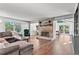 Spacious living room boasts a brick fireplace, hardwood floors, and plenty of natural light at 2480 Roxburgh Dr, Roswell, GA 30076