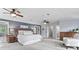 Large main bedroom with ceiling fans, sitting area, ensuite access, and neutral tones at 2480 Roxburgh Dr, Roswell, GA 30076