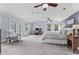 Expansive main bedroom with seating area, desk space, multiple windows, and ceiling fans at 2480 Roxburgh Dr, Roswell, GA 30076