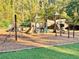 Community playground with climbing structures, slides, and soft landing surfaces for to explore at 2480 Roxburgh Dr, Roswell, GA 30076