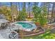 Beautiful backyard featuring a kidney-shaped pool, an outdoor dining area, and lush landscaping at 2480 Roxburgh Dr, Roswell, GA 30076
