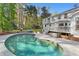 Private backyard pool with a lush lawn, mature trees, and an inviting outdoor seating area, perfect for relaxation at 2480 Roxburgh Dr, Roswell, GA 30076