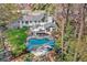 Aerial view of the private backyard oasis with a uniquely shaped pool and ample lounge space at 2480 Roxburgh Dr, Roswell, GA 30076