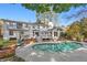 Aerial view of a kidney shaped pool and back deck in a lush backyard, enhancing the property's appeal at 2480 Roxburgh Dr, Roswell, GA 30076