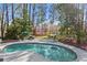 Backyard oasis with a refreshing pool, lounge chairs, mature trees, and a tranquil outdoor setting at 2480 Roxburgh Dr, Roswell, GA 30076