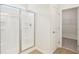 Bright bathroom featuring a glass-enclosed shower and an adjacent walk-in closet at 28 Kensington St, Kingston, GA 30145