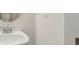 Elegant bathroom with a modern sink, round mirror, and white walls at 28 Kensington St, Kingston, GA 30145