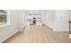 Open-concept living room and kitchen featuring wood-look floors and plenty of natural light at 28 Kensington St, Kingston, GA 30145