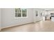 Open-concept living room and kitchen featuring wood-look floors and large windows at 28 Kensington St, Kingston, GA 30145