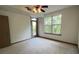Bedroom featuring plush carpet, a ceiling fan, and a door that leads to a balcony at 390 17Th Nw St # 4037, Atlanta, GA 30363