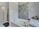 Soaking tub with a modern tiled backsplash and a glass enclosed shower visible in this bathroom at 5 Burns View Ct, Lawrenceville, GA 30044