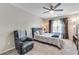 Spacious bedroom with a plush chair, soft carpet, ceiling fan and lots of natural light at 5 Burns View Ct, Lawrenceville, GA 30044