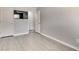 Bright room featuring wood floors, two doors, and a wall-mounted television at 5 Burns View Ct, Lawrenceville, GA 30044