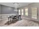 Formal dining room with wood-look floors and stylish chandelier and lighting at 5 Burns View Ct, Lawrenceville, GA 30044