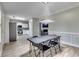 Eat-in kitchen with white cabinets, stainless appliances, fireplace, decorative lighting, and dining table at 5 Burns View Ct, Lawrenceville, GA 30044
