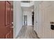 Bright hallway with wood-look floors, a view of the stairs, and a bathroom at 5 Burns View Ct, Lawrenceville, GA 30044