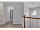 Upstairs hallway with natural light, carpeted floors, wooden railing, and white banisters at 5 Burns View Ct, Lawrenceville, GA 30044