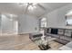 Cozy living room featuring modern decor, wood-look flooring, neutral colors, and natural light at 5 Burns View Ct, Lawrenceville, GA 30044