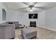 Cozy living room featuring a modern sofa, fireplace, and a ceiling fan with lights at 5 Burns View Ct, Lawrenceville, GA 30044