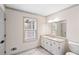 Bathroom featuring a large vanity with granite countertop, a framed mirror, and marble tile flooring at 906 John Ct, Lawrenceville, GA 30046