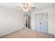 A cozy bedroom featuring plush carpeting, a ceiling fan, and a closet with gray painted doors at 906 John Ct, Lawrenceville, GA 30046