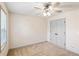 Bedroom featuring neutral carpeting, a ceiling fan, and a double door closet for storage at 906 John Ct, Lawrenceville, GA 30046