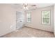 Cozy bedroom featuring neutral carpeting, a ceiling fan, and a double door closet for storage at 906 John Ct, Lawrenceville, GA 30046