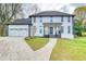 Inviting home showcasing an attached garage and manicured lawn at 906 John Ct, Lawrenceville, GA 30046