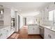 Kitchen with white cabinets and stainless appliances overlooking the dining area at 906 John Ct, Lawrenceville, GA 30046