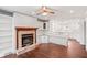 Inviting living room with a fireplace, built-in shelves, and hardwood floors at 906 John Ct, Lawrenceville, GA 30046