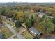 Aerial view of a quiet neighborhood with mature trees and an updated home with a modern exterior at 1970 Capri Dr, Decatur, GA 30032