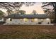 Expansive backyard featuring a freshly painted white brick home with a dark roof at 1970 Capri Dr, Decatur, GA 30032