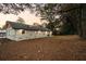 Large backyard featuring a freshly painted white brick home with a dark roof at 1970 Capri Dr, Decatur, GA 30032