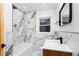 Chic bathroom showcasing a marble-style tiled shower and backsplash with black hardware at 1970 Capri Dr, Decatur, GA 30032