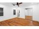 Bright bedroom with hardwood floors, a ceiling fan, and mirrored closet doors at 1970 Capri Dr, Decatur, GA 30032