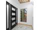 Modern entryway featuring a black front door with windows and marble tile floors at 1970 Capri Dr, Decatur, GA 30032