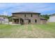 Spacious backyard with a covered patio and lush green grass, perfect for outdoor living at 205 Haverling Pass, Hampton, GA 30228
