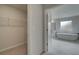 Modern bathroom view showcasing the tub and marble floors near a sizable walk-in closet at 205 Haverling Pass, Hampton, GA 30228