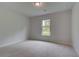Bright bedroom features plush carpet and a window with natural light at 205 Haverling Pass, Hampton, GA 30228