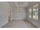 Elegant dining room with coffered ceilings, wainscoting, and large windows for ample natural light at 205 Haverling Pass, Hampton, GA 30228
