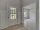 Bright entryway with a stylish front door and light hardwood floors leading into the home at 205 Haverling Pass, Hampton, GA 30228