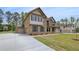 Spacious home showcasing a convenient three-car garage and brick exterior at 205 Haverling Pass, Hampton, GA 30228