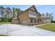 Spacious home showcasing a convenient three-car garage and brick exterior at 205 Haverling Pass, Hampton, GA 30228