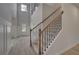 Grand two-story foyer featuring wood staircase, wainscoting, and an abundance of natural light at 205 Haverling Pass, Hampton, GA 30228