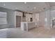 Spacious kitchen with a large island, white cabinets, and an open layout to the living space at 205 Haverling Pass, Hampton, GA 30228