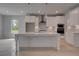 Bright kitchen features white cabinets, stainless steel appliances, quartz countertops, and pendant lighting at 205 Haverling Pass, Hampton, GA 30228