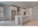Bright kitchen features white cabinets, stainless steel appliances, quartz countertops, and pendant lighting at 205 Haverling Pass, Hampton, GA 30228