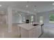 Living room with kitchen, fireplace, and sliding door with access to the backyard at 205 Haverling Pass, Hampton, GA 30228